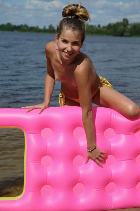 Ukrainian beauty Lola Krit strips on a floaty and displays her tits and holes