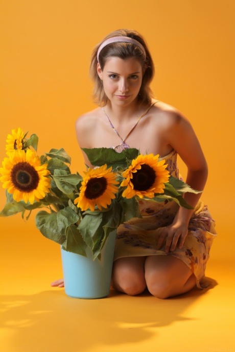 Sexy teen beauty Vienna flaunts her big tits and poses with sunflowers