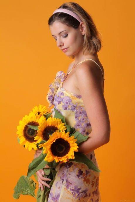 Sexy teen beauty Vienna flaunts her big tits and poses with sunflowers