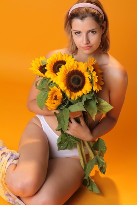 Sexy teen beauty Vienna flaunts her big tits and poses with sunflowers