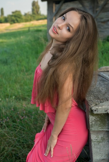 Cute brunette teen Arina G exposes her pussy and poses nude in the countryside