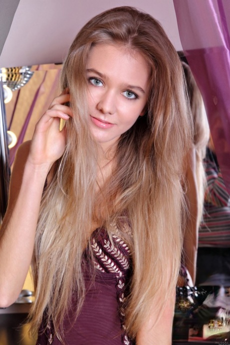 Beautiful teen Sara B undresses & shows off her slender naked body