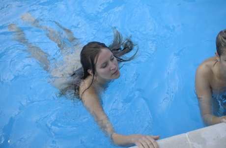 Teens Iveta B & Yana B lose their bikinis and swim butt naked in the pool