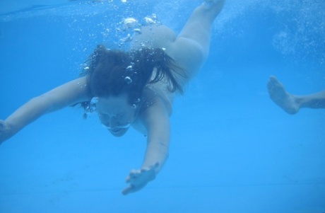 Teens Iveta B & Yana B lose their bikinis and swim butt naked in the pool