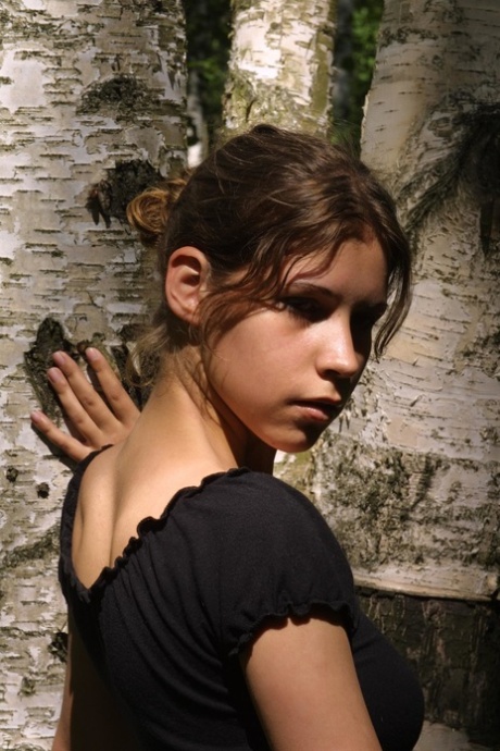 Adorable petite teen Gillian unveils her hot body and poses in the woods
