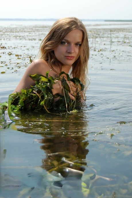 Cute babe with natural tits Masota teases with her wet naked body in a river