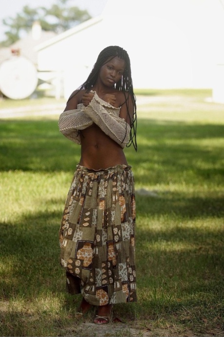Sexy ebony teen Deserea bares her great natural big tits outdoors