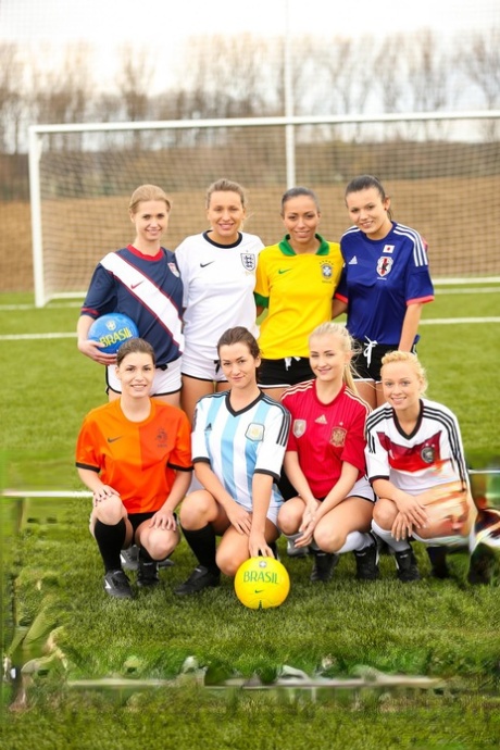 Kinky soccer babes strip each other and flaunt their titties on a soccer pitch