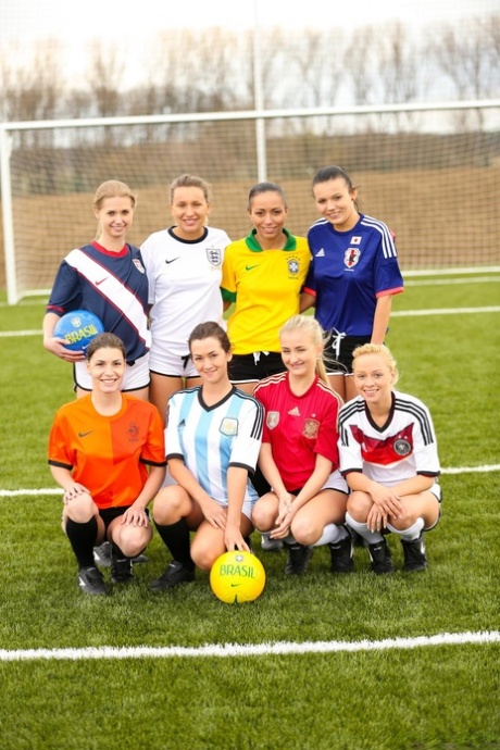 Kinky soccer babes strip each other and flaunt their titties on a soccer pitch