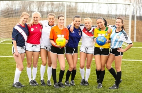 Kinky soccer babes strip each other and flaunt their titties on a soccer pitch