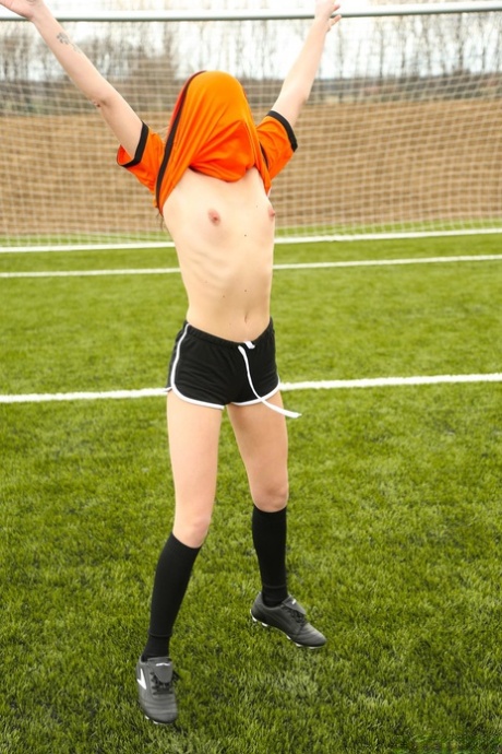 Kinky soccer babes strip each other and flaunt their titties on a soccer pitch