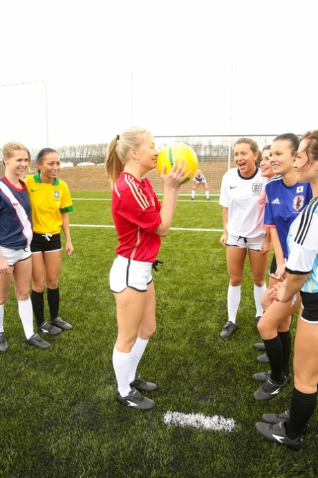 Kinky soccer babes strip each other and flaunt their titties on a soccer pitch
