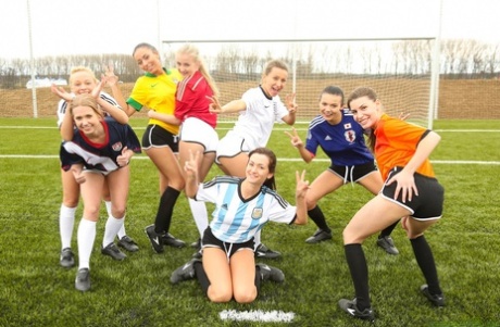 Kinky soccer babes strip each other and flaunt their titties on a soccer pitch