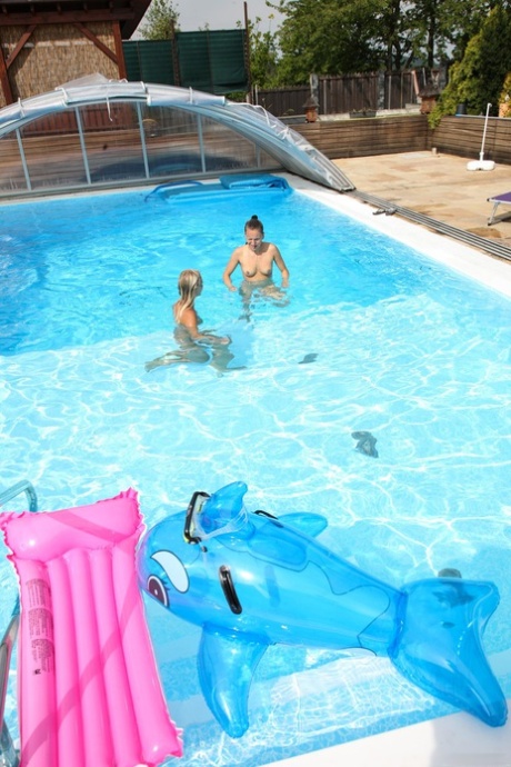 Lesbians Sara J & Nessy swim naked in the pool, French kiss and lick pussy