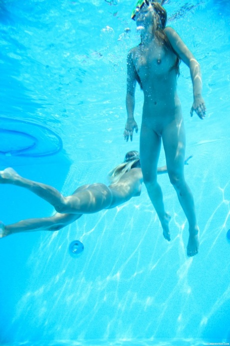 Lesbians Sara J & Nessy swim naked in the pool, French kiss and lick pussy