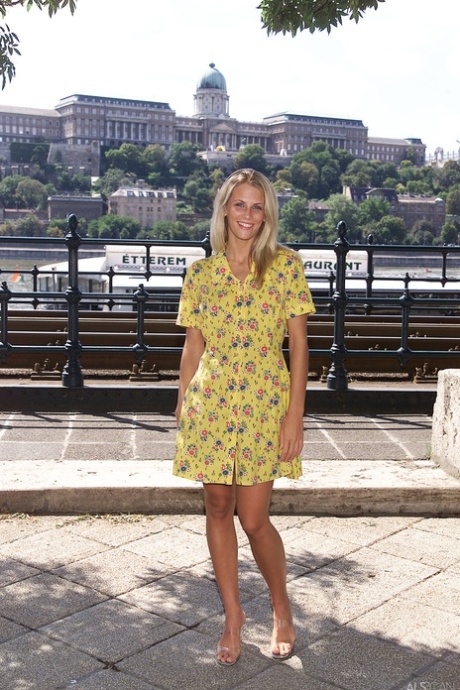 Blonde teen Krisztina removes her yellow dress and flaunts her body in public