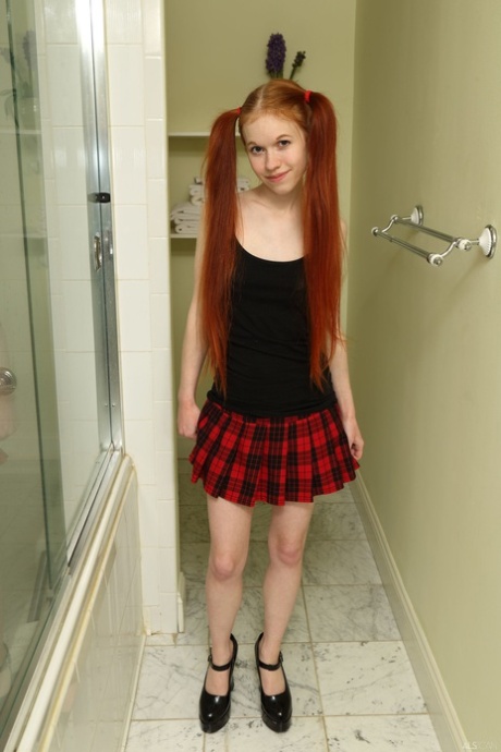 Petite teen Dolly Little squats down and takes a leak in the hallway