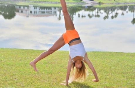 Cute teen Serena doffs her clothes to show her ass and poses in a park