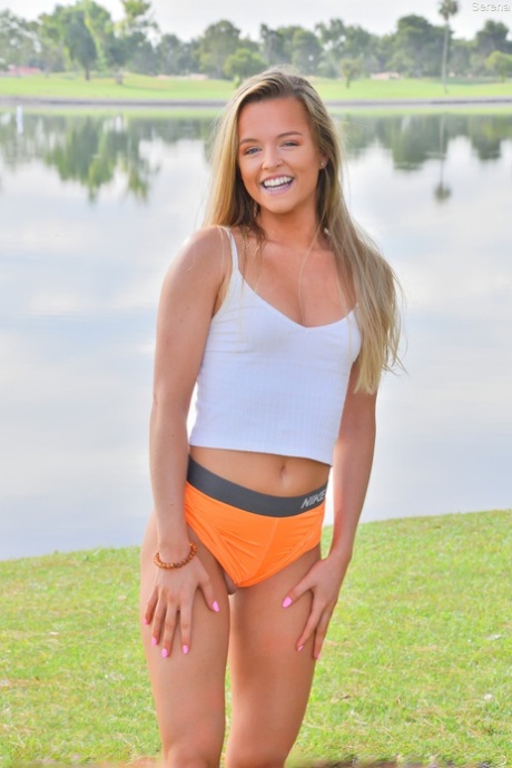 Cute teen Serena doffs her clothes to show her ass and poses in a park