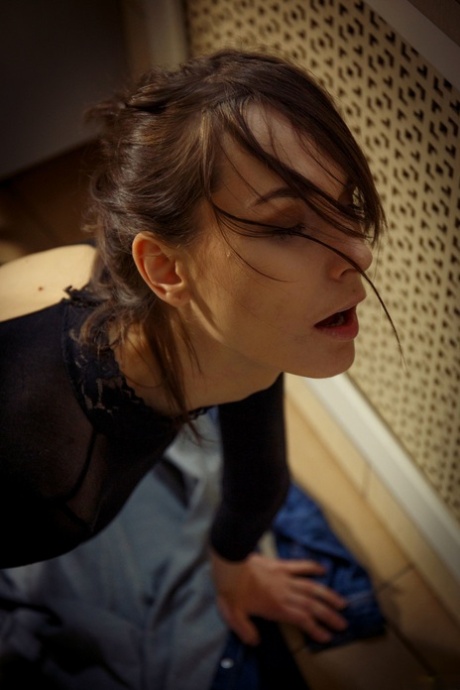 Glamorous brunette Poppy masturbates in her sexy bodystocking in the washroom