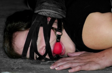 Submissive brunette Kayden Faye gets bound with straps and put in the stocks