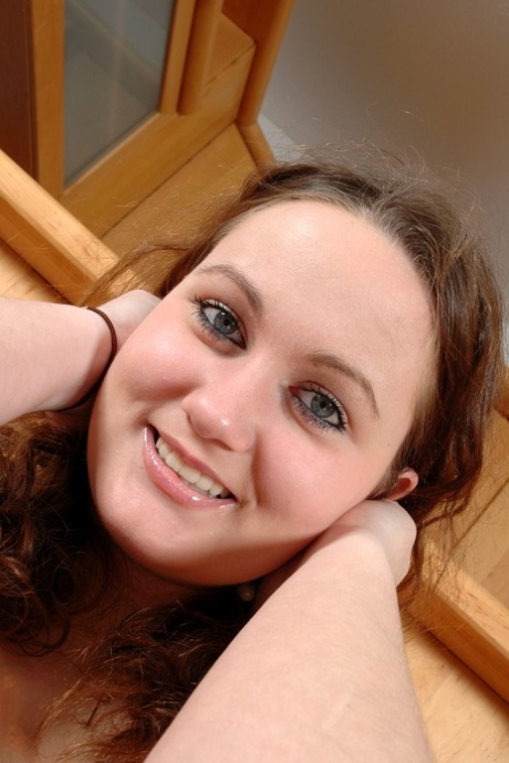 Roly-poly amateur Julie strips naked then fondles her big natural tits