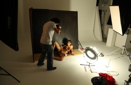 Slim teen Little Caprice poses in stockings & chocolate at a photo shoot
