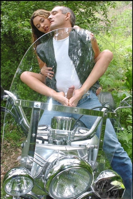 Sweet curly haired babe Vivien L gets rammed on a motorbike in the woods