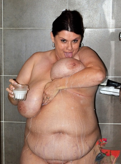 Gorgeous MILF fatty Kimmie Kaboom showering her big natural tits with milk