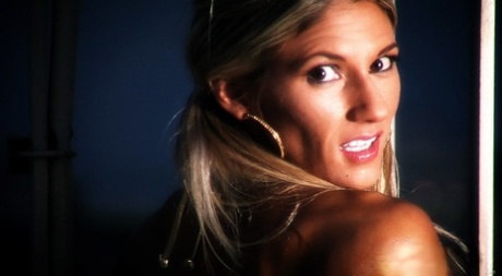 MILF bodybuilder with a cute face Abby Marie flexing her oiled muscles