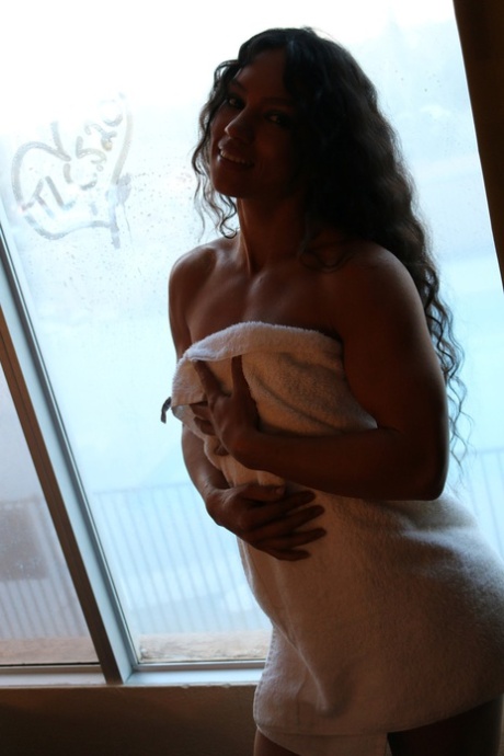 Stunning bodybuilder Tia poses in a bikini & struts nude in a public toilet