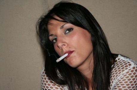 Amateur Korri smokes a cigarette & flaunts her big natural boobs on a terrace