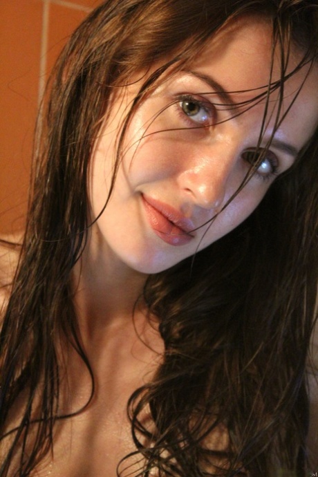 Brunette teen Holly Haim strips & washes her big tits in the shower