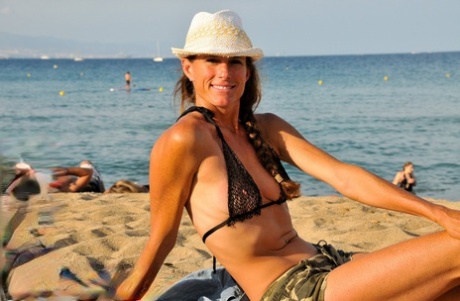 Tall brunette Sofie Marie poses in her leopard bikini top & shorts in public