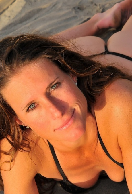 Horny pornstar with a slim body Sofie Marie flaunts her body on the beach