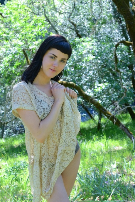 Adorable amateur babe Myre strips in an orchard and shows her hairy armpits