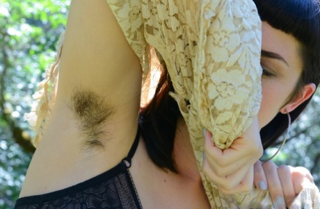 Adorable amateur babe Myre strips in an orchard and shows her hairy armpits