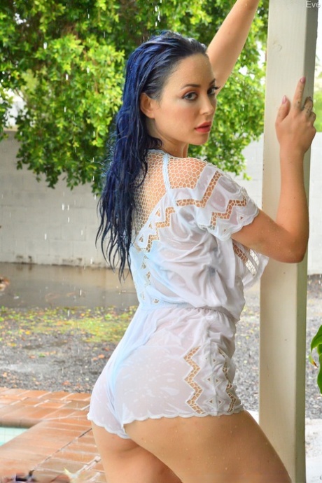 Blue-haired stunner Eve toys with a glass dildo while showing off her big tits