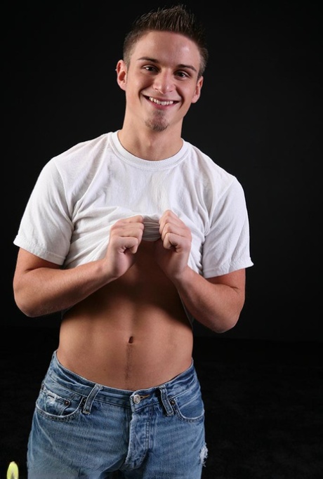 Cute gay Gerin doffs his shirt and jeans and jerks off his rock hard dick