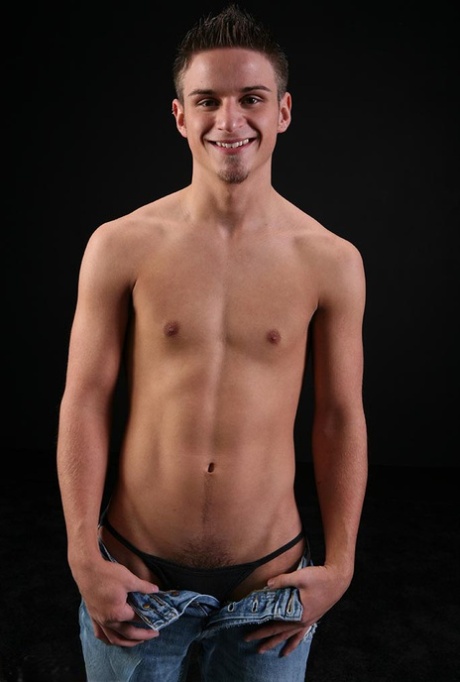Cute gay Gerin doffs his shirt and jeans and jerks off his rock hard dick