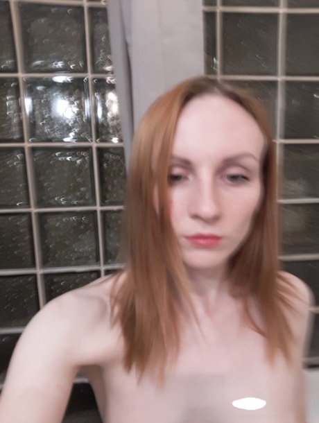 Amateur ginger flaunting her small boobs and skinny body in the mirror