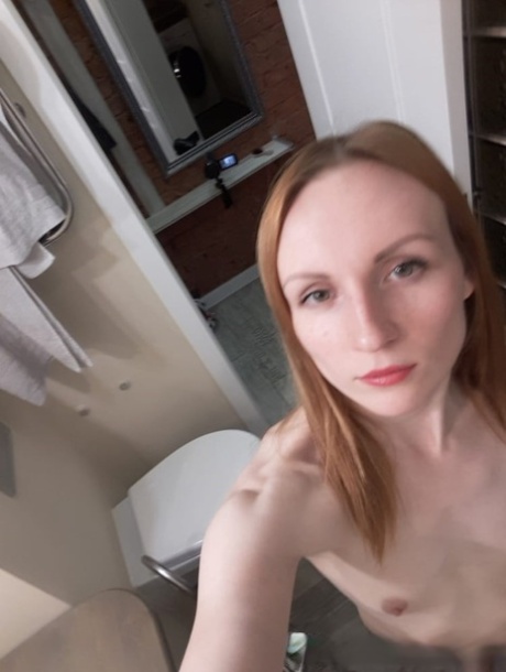 Amateur ginger flaunting her small boobs and skinny body in the mirror