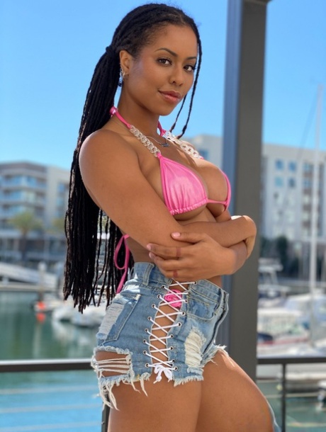 Curvy ebony Kira Noir exposes her firm fake tits before a blowjob & big facial
