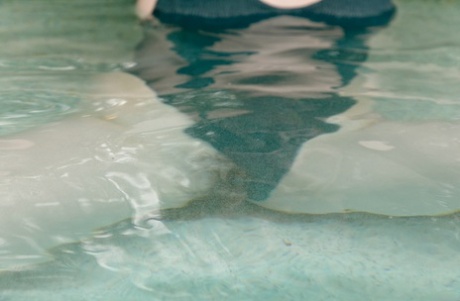 Amateur babe Ophelia Palantine flaunts her ass & shows her big tits in a pool