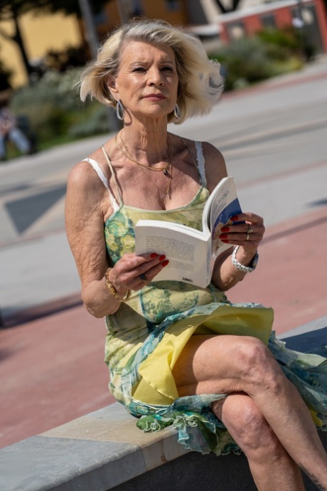 Blonde granny Eva Delage exposes her lovely breasts and takes two cocks deeply