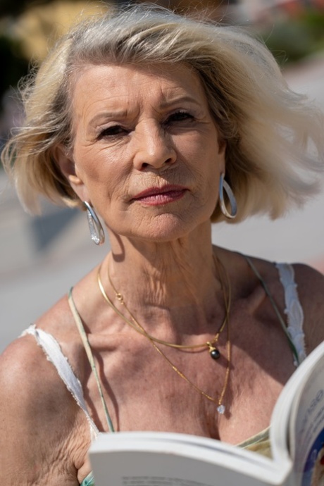 Blonde granny Eva Delage exposes her lovely breasts and takes two cocks deeply