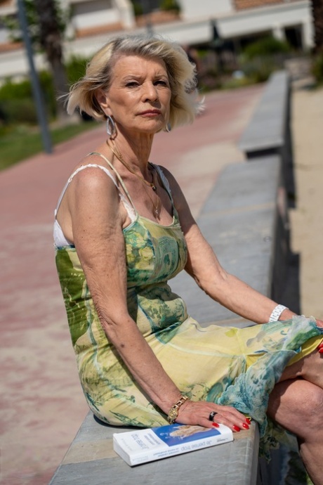 Blonde granny Eva Delage exposes her lovely breasts and takes two cocks deeply