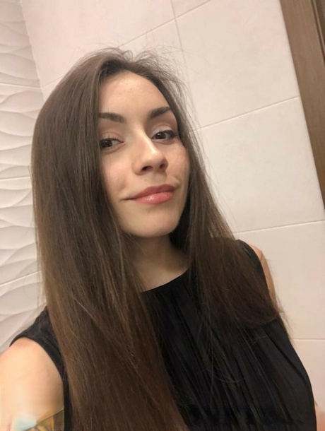 Brunette American takes selfies of her medium tits and round booty