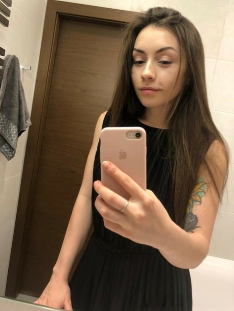 Brunette American takes selfies of her medium tits and round booty