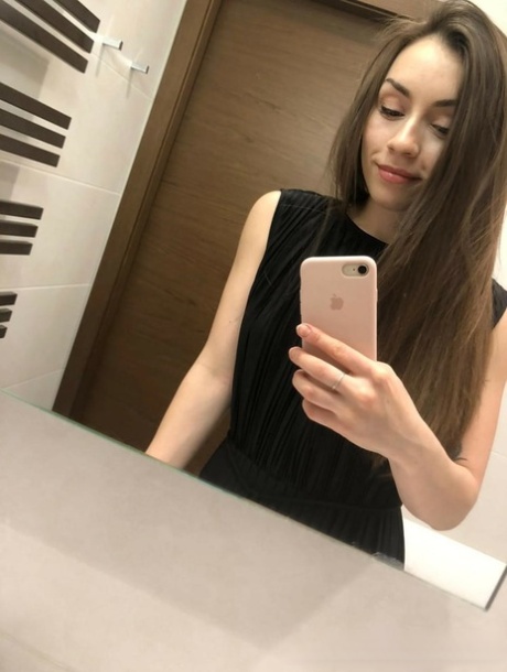 Brunette American takes selfies of her medium tits and round booty